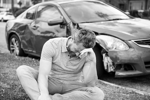 Seguro de automóvil Triste asistencia de hombre deprimido con automóvil roto en la carretera