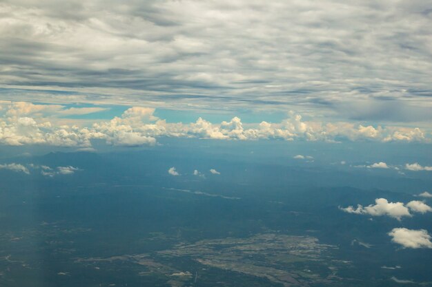 Sehen Sie über Wolken und blauem Himmel auf Flugzeug an.