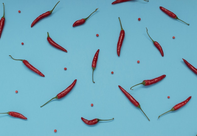 Sehr scharfe Chilischoten auf blauem Papierhintergrund