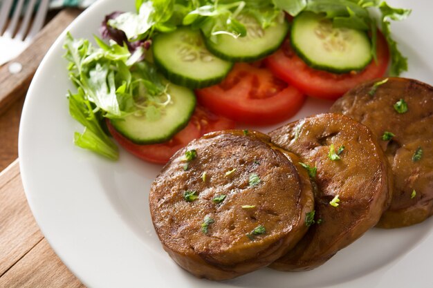 Seitan con verduras en la mesa de madera. Carne falsa