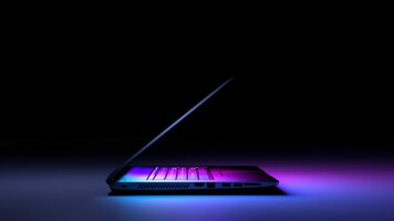 Foto seitenansicht des laptop-pcs mit farblicht auf dunkelheit. technologie-gaming-konzept.
