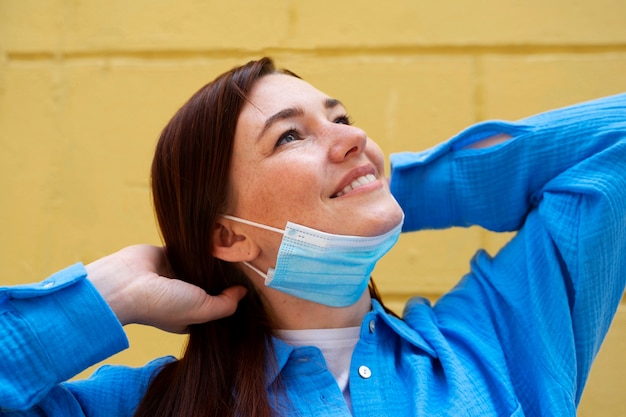 Foto seitenansichtsfrau, die maske abnimmt