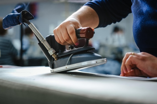 Selektive Fokusaufnahme einer Näherin, die in einer Werkstatt arbeitet