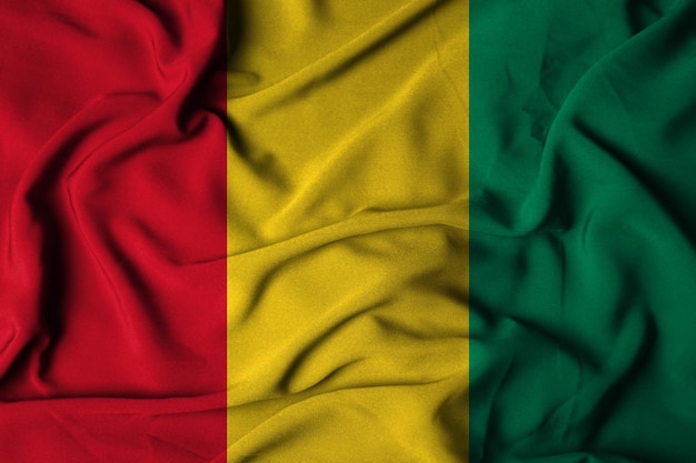 Selektiver Fokus der guinea-Flagge mit wehender Stoffstruktur. 3D-Darstellung