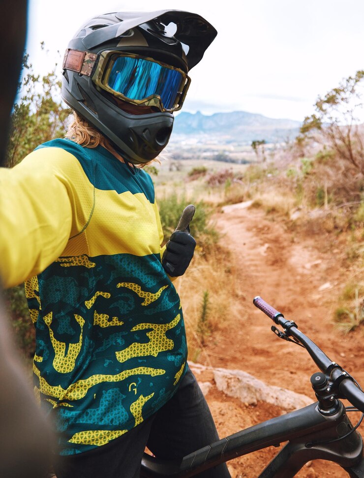 Foto selfie en bicicleta y pulgares hacia arriba por un hombre en bicicleta en la naturaleza para entrenamiento deportivo y cardio en camino de tierra influenciador de fitness y firma de agradecimiento de mano por ciclista para redes sociales en línea y blog deportivo