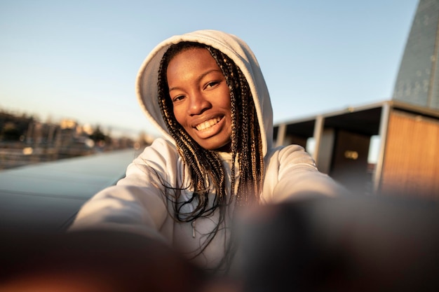 Selfie de jovem africana no mochileiro viajante da cidade