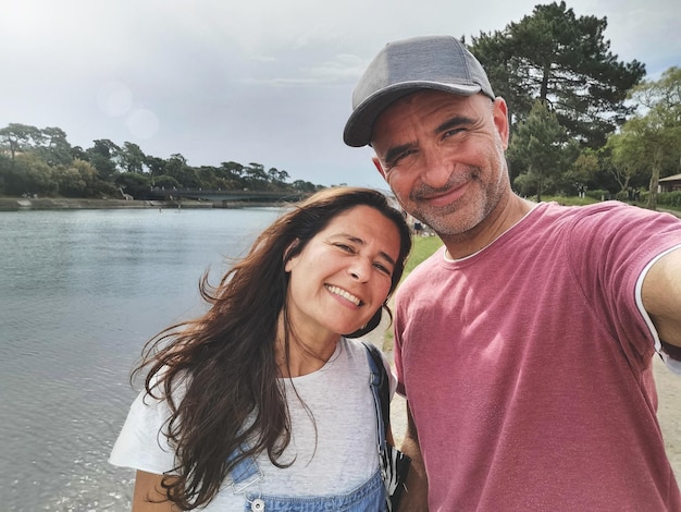 Foto selfy de um atraente casal de meia-idade sorrindo e aproveitando seu tempo livre