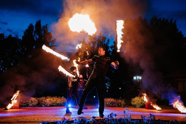 SEMIGORYE RUSIA 17 DE JUNIO DE 2022 Espectáculo de fuego por la noche en el evento del festival Un equipo de personas organiza una actuación brillante