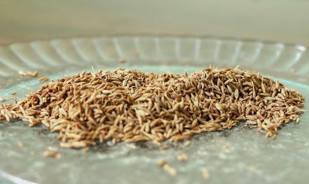 Semillas de comino Jeera en un plato sobre el fondo de madera