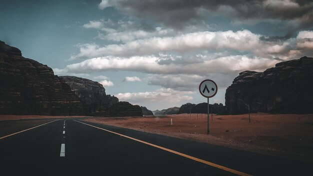 Foto señal de carretera por montaña contra el cielo