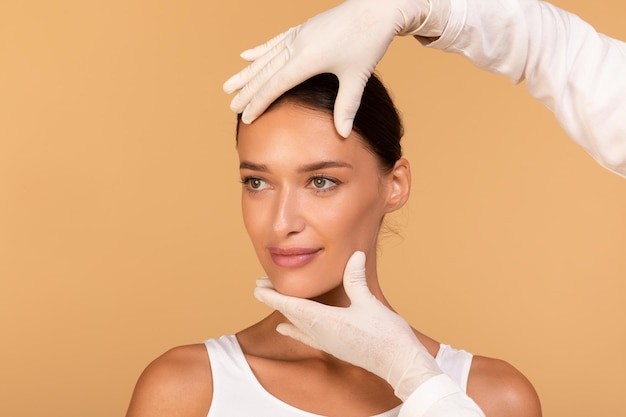 Foto senhora recebendo tratamento na clínica de cosmetologia mudando sua aparência cirurgião plástico tocando lindo rosto feminino