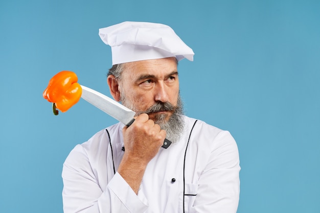 Senior Chef Holding Knife Studio Shot