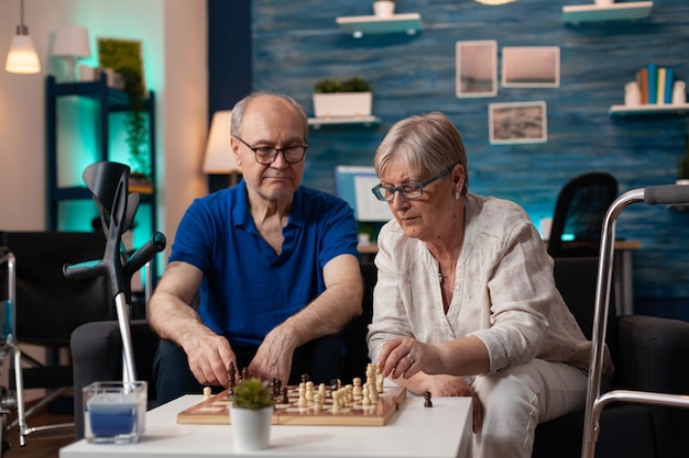 Senior hombre y mujer se centró en el partido del juego de mesa