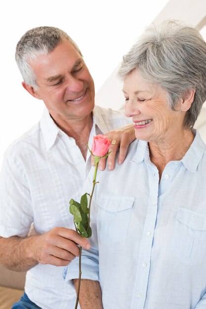 Senior hombre ofreciendo una rosa a su compañero