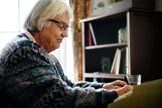 Senior mujer escribiendo una carta