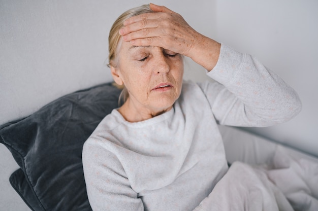 Senior mujer sentirse mal en la cama