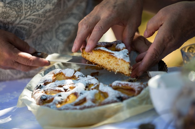 Sênior mulher servindo café da manhã no jardim