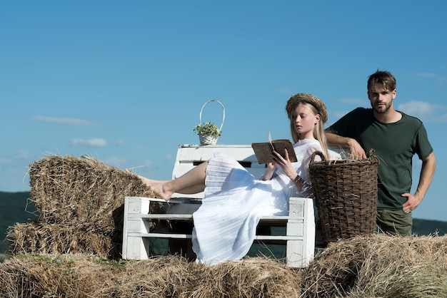 Sensual mujer leer libro para hombre Mujer novia en vestido de novia relajarse en el banco Pareja enamorada de vacaciones Familia disfrutar de la naturaleza de verano Novia y novio cita al aire libre