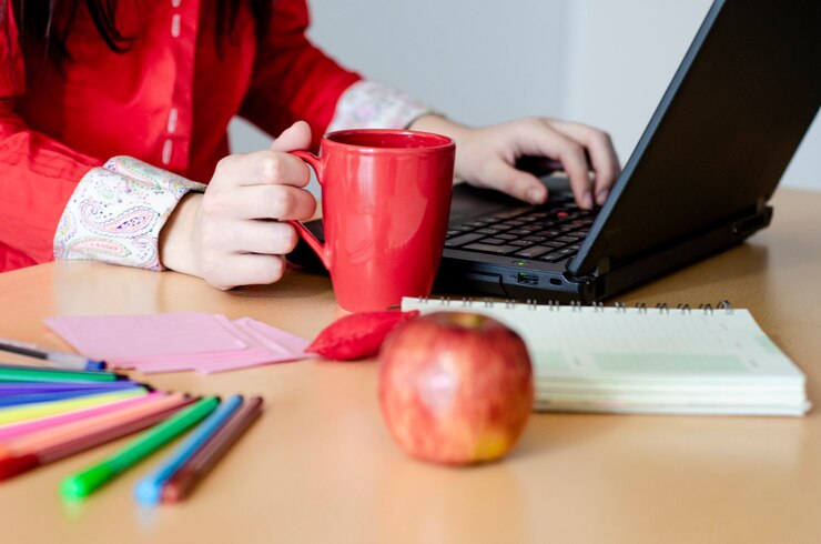 Foto el sentarse de trabajo del empresario de sexo femenino joven en un escritorio que mecanografía en su ordenador portátil en un ministerio del interior.