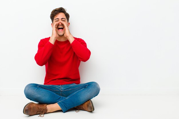 sentindo-se feliz, animado e positivo, dando um grande grito com as mãos ao lado da boca, gritando