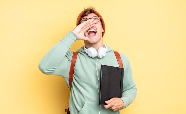 Sentindo-se feliz, animado e positivo, dando um grande grito com as mãos perto da boca, gritando. conceito de estudante