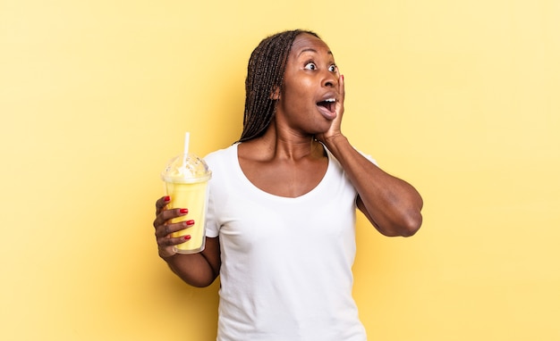 Sentindo-se feliz, animado e surpreso, olhando para o lado com as duas mãos no rosto. conceito de milkshake