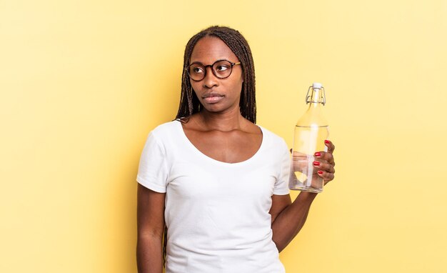 Sentirse triste, molesto o enojado y mirar hacia un lado con una actitud negativa, fruncir el ceño en desacuerdo. concepto de botella de agua