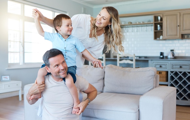 Ser una familia significa que eres parte de algo. Toma de dos padres jugando con su hijo en casa.