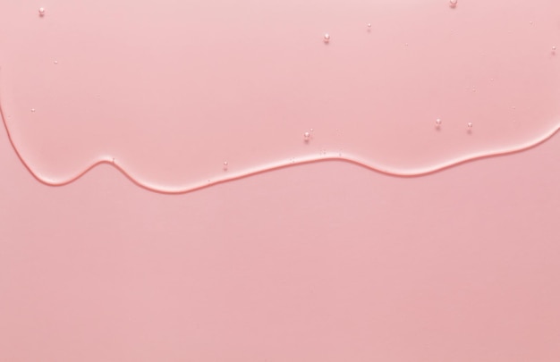 Serum cosmético de beleza em fundo rosa