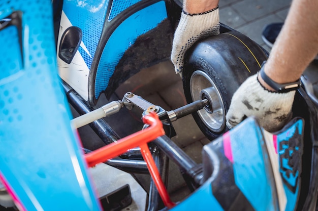 El servicio mecánico de carreras de karts cambia las ruedas.