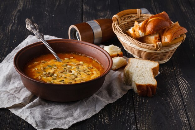 Serviert auf rustikalem Tisch, traditionelle Gewürzkürbissuppe in Schüssel