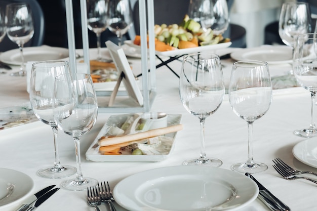 Serviertisch mit Snacks und leeren Weingläsern