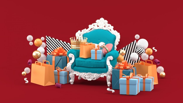 Sessel, Kronen, Ringe und Geschenke inmitten bunter Kugeln auf Rot. 3D-Rendering.