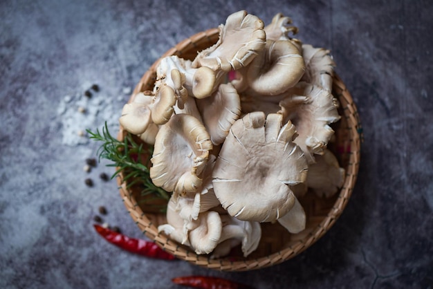 Seta de ostra gris en la cesta seta de ostra cruda fresca con hierbas y especias para cocinar alimentos