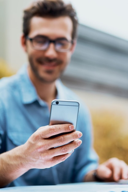 Siempre está al tanto Captura de un joven usando un teléfono celular al aire libre