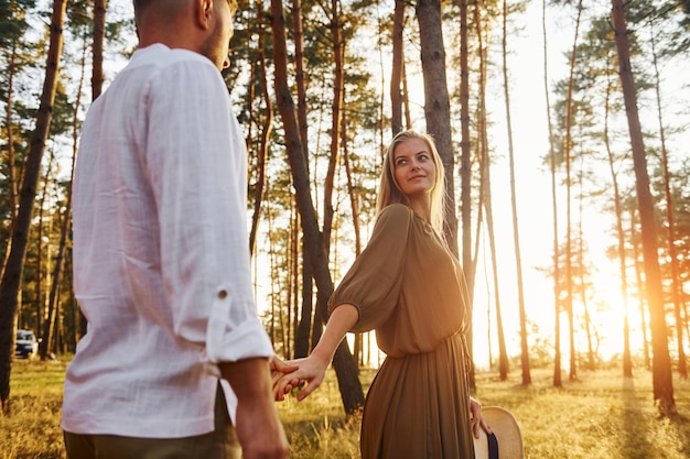 Siga-me o conceito Casal feliz está ao ar livre na floresta durante o dia