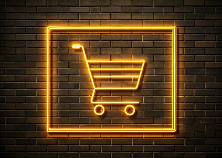 Foto signo de carrito de compras de neón con fondo de pared de ladrillo para la venta
