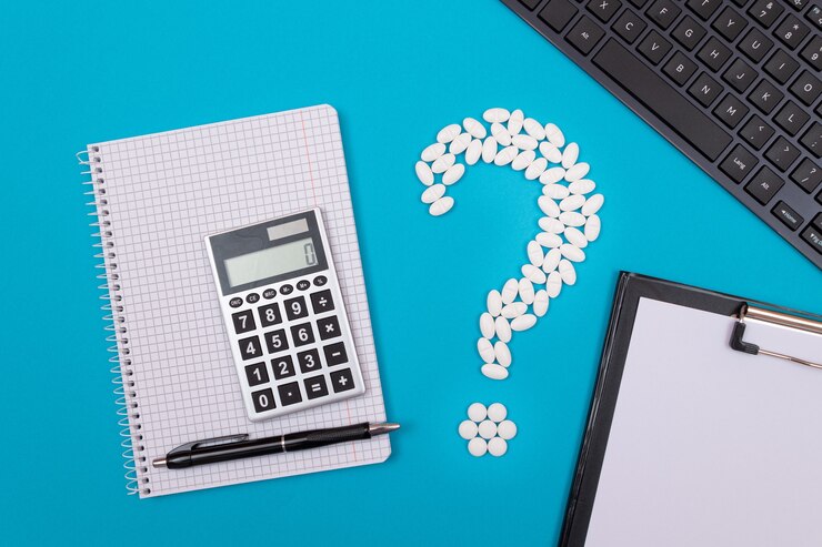 Foto signo de interrogación blanco y calculadora industria farmacéutica y productos medicinales