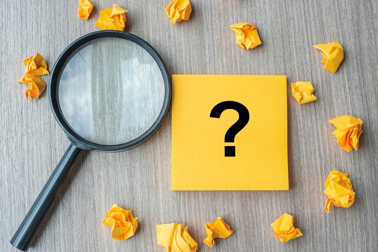 Foto signo de interrogación (?) palabra en nota amarilla con papel desmenuzado