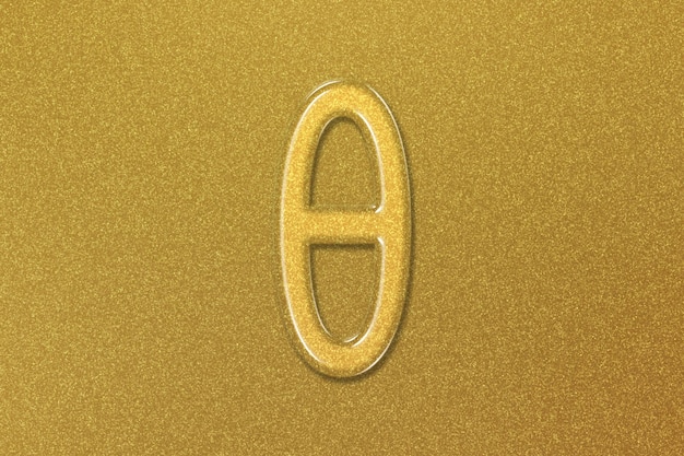 Foto signo teta. letra theta, símbolo del alfabeto griego, fondo dorado