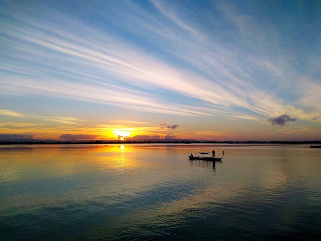 Silhouette-Boot auf dem Meer gegen den Himmel bei Sonnenuntergang