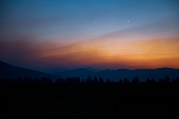 Silhueta de árvores nas colinas ao pôr do sol em Montana