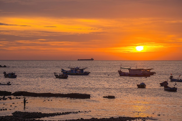 Silhueta de pescador usando a frente da haste do belo fundo do pôr do sol cinematográfico Roda da vara de pescar closeup homem pescando com um belo nascer do sol atrás dele