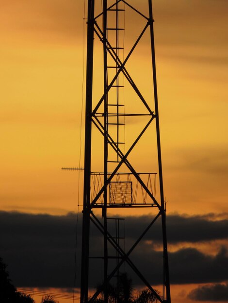 Foto silhueta de um pilar de eletricidade contra o céu durante o pôr do sol