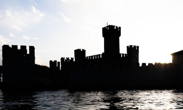 Silhueta do castelo Itália Sirmone no lago Garda ao pôr do sol Arquitetura medieval com torre