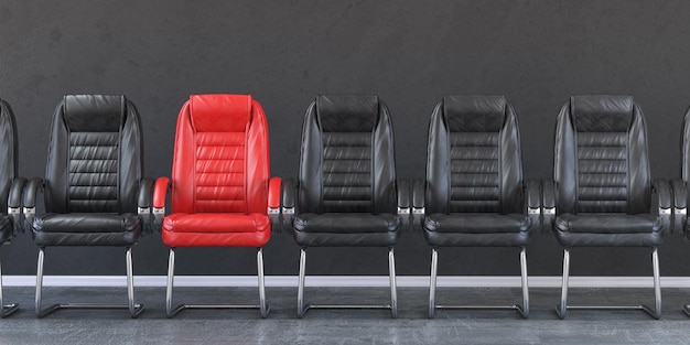 Silla roja en una fila de sillas negras en una oficina Concepto de reclutamiento y empleo de liderazgo empresarial