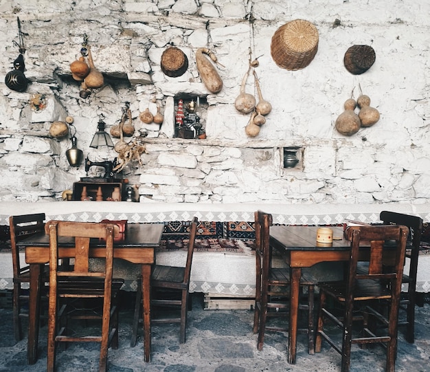 Foto sillas vacías y mesa contra la pared