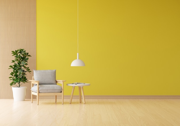 Sillón gris en salón amarillo con planta y mesa