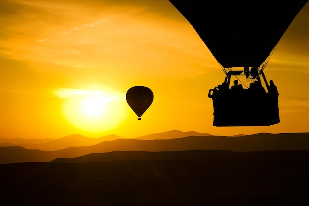 Silueta de globo caliente con fondo de cielo de amanecer