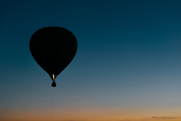 Silueta de globo volador en cielo nocturno